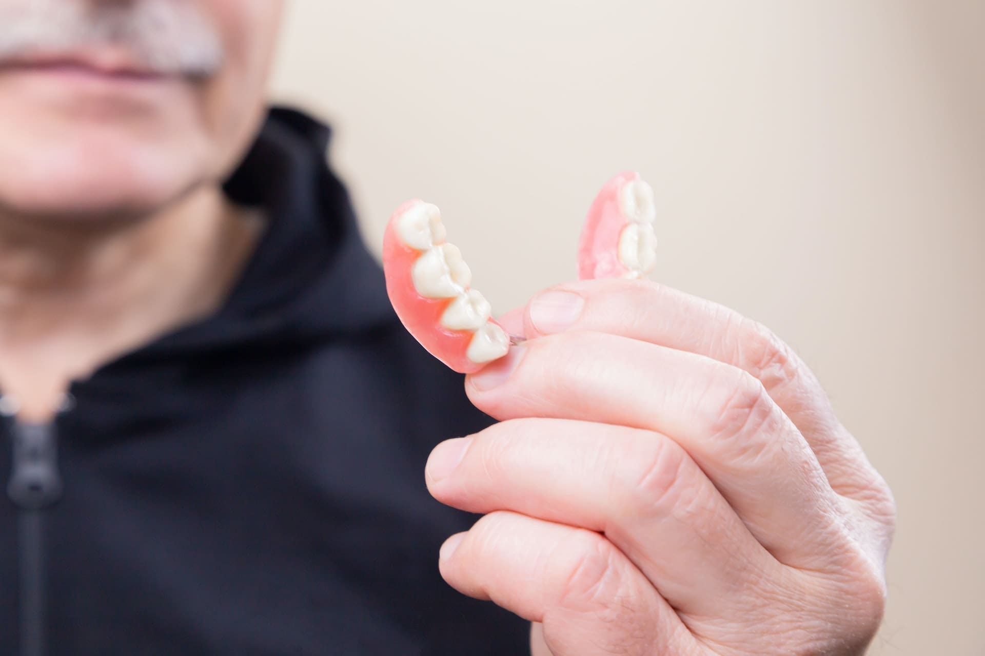 person holding dentures