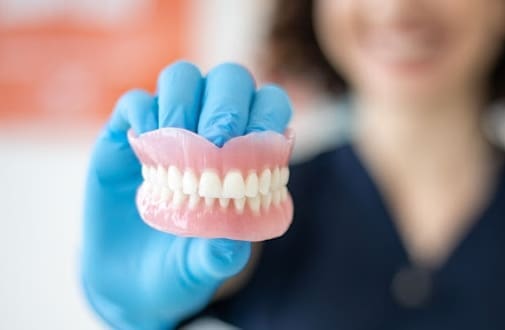 woman holding a jaw model