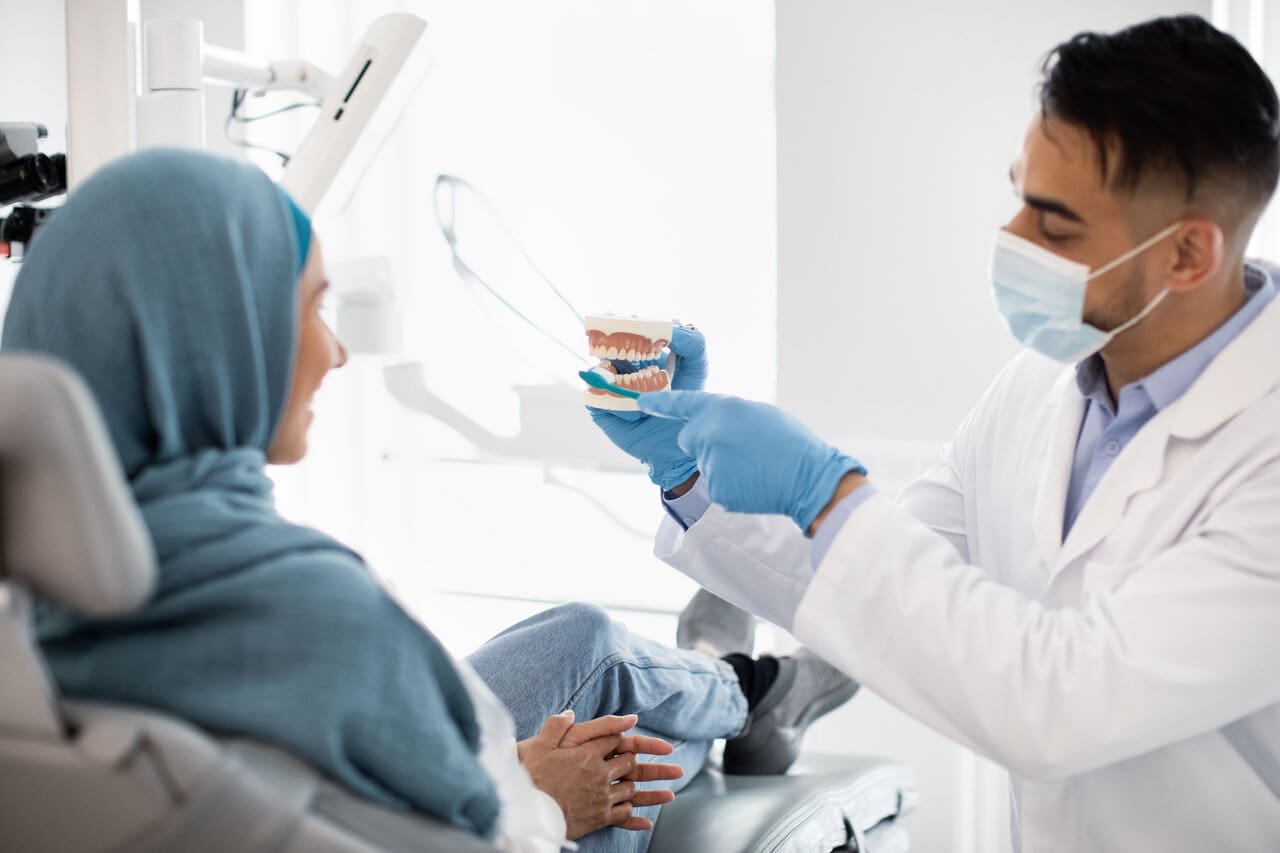 dentist holding jaw model