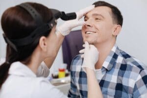 dentist looking at patient's teeth