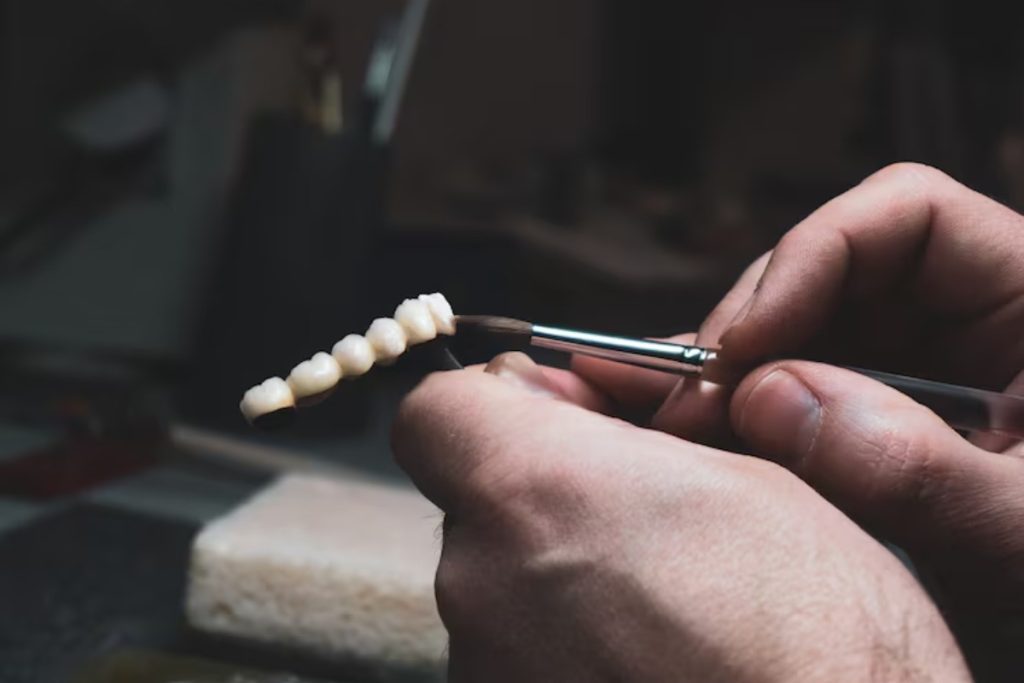 dentist creating a dental crown bridge for front teeth restoration