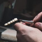 dentist creating a dental crown bridge for front teeth restoration