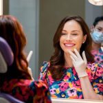 patient admiring her new smile after cosmetic dentistry